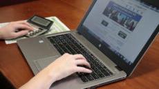 Person browsing financial aid site on laptop